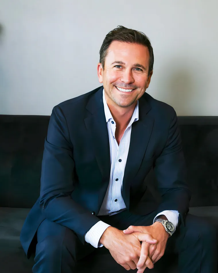 Neil Bourdelaise, mortgage lender with Main Street Home Loans, smiling in a navy suit